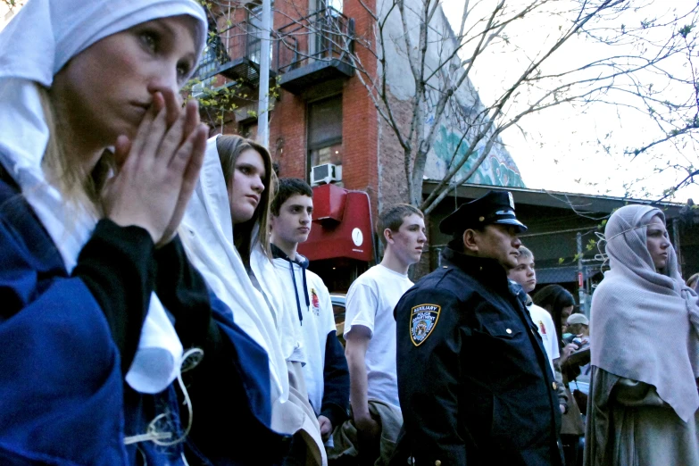 the woman has been standing with her hands together in front of the police officers