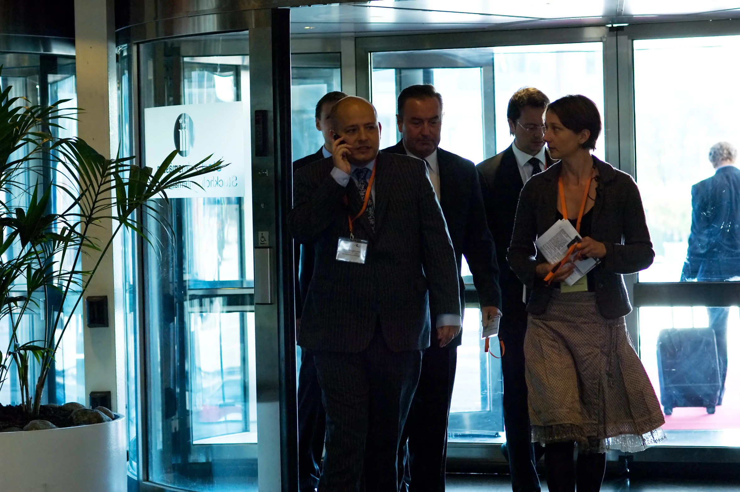 several people standing in front of a glass door