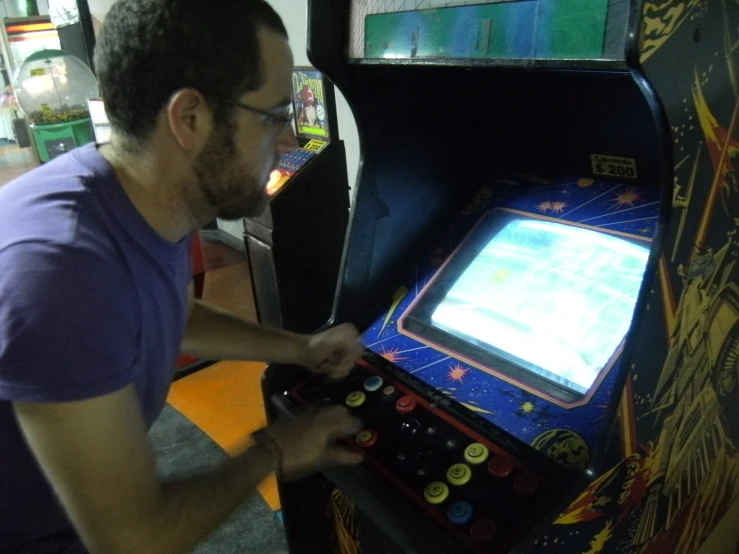 a man playing the video game arcade