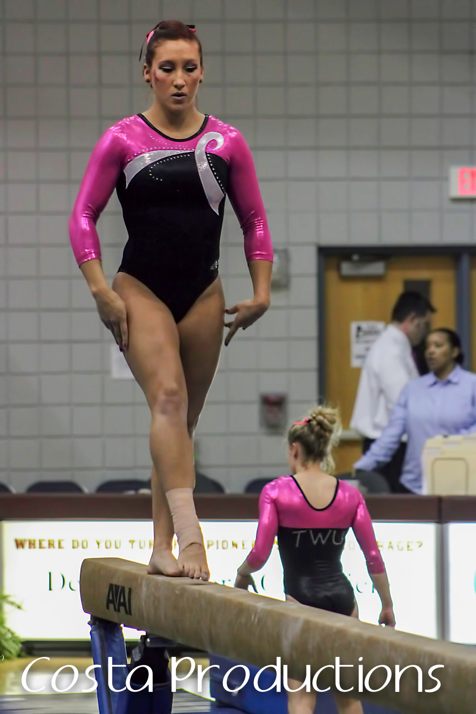 some young woman standing on a balance beam