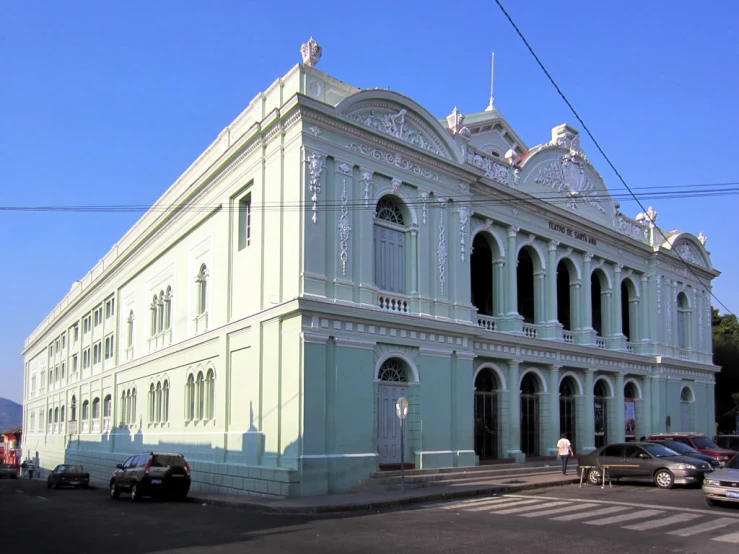 an old building is standing in front of a street corner