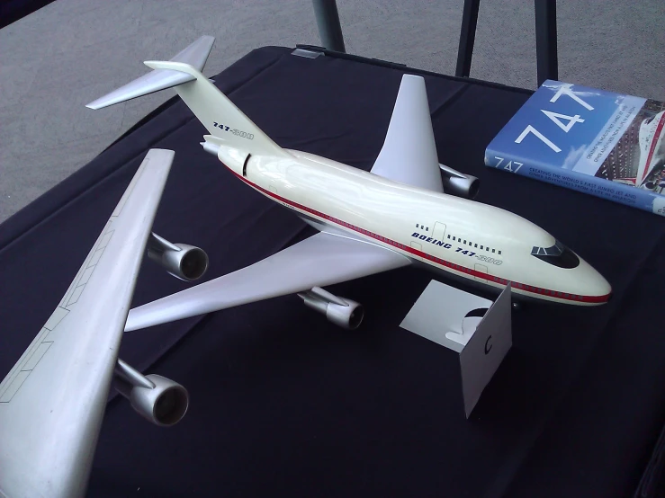 a model airplane sits on display next to a book