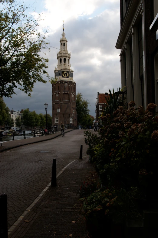 an old fashioned clock tower is on a cloudy day