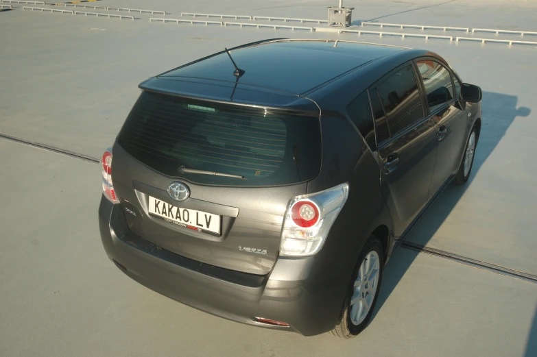 a gray toyota car parked next to an open roof