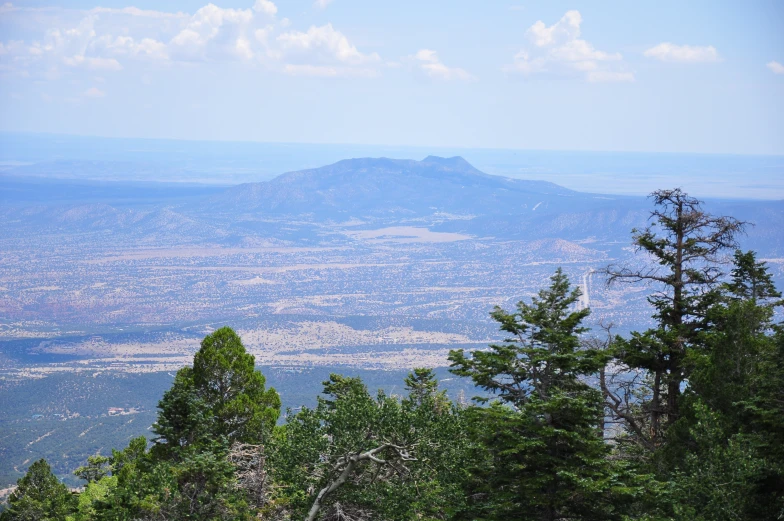 a view of a beautiful countryside from the top of a hill