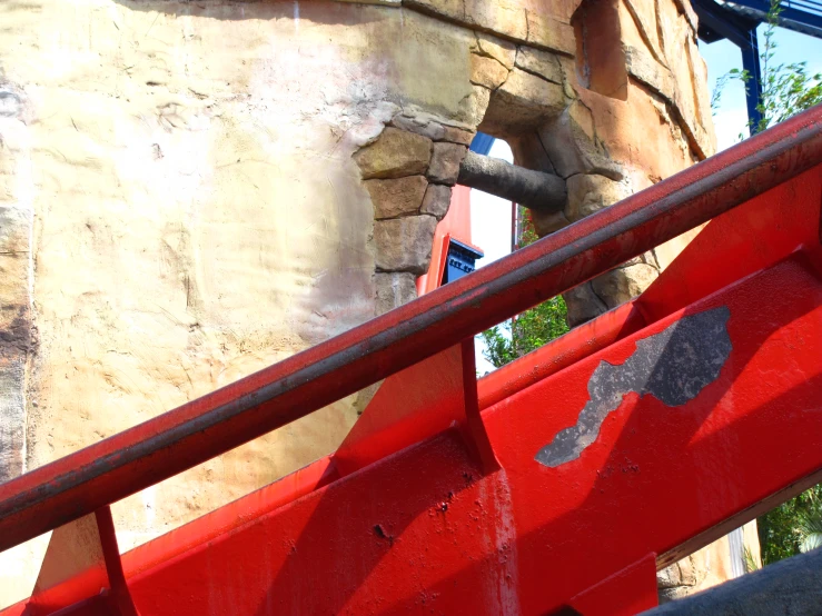 a large red iron railing with soing black on it