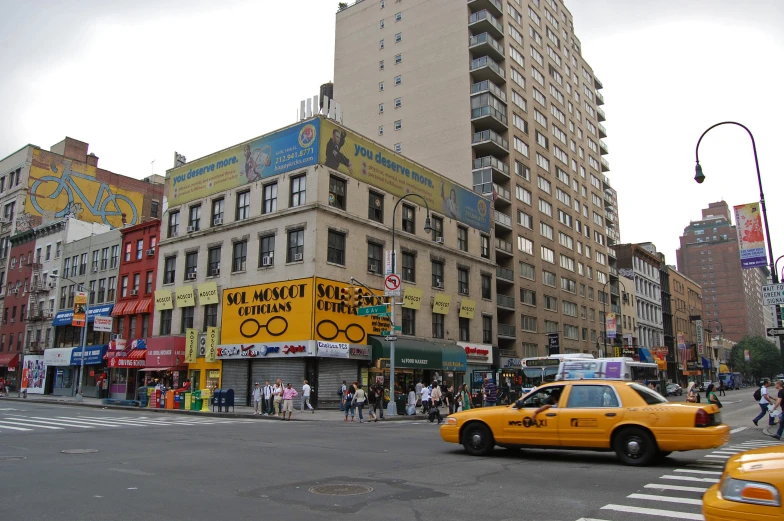 a busy intersection in a big city with many tall buildings