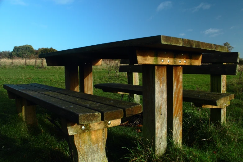 a couple of benches sitting in a field