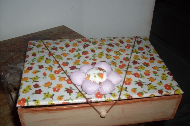 a box with flowers and teddy bears on the lid