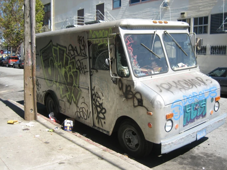 a parked van with graffiti on the side of the street