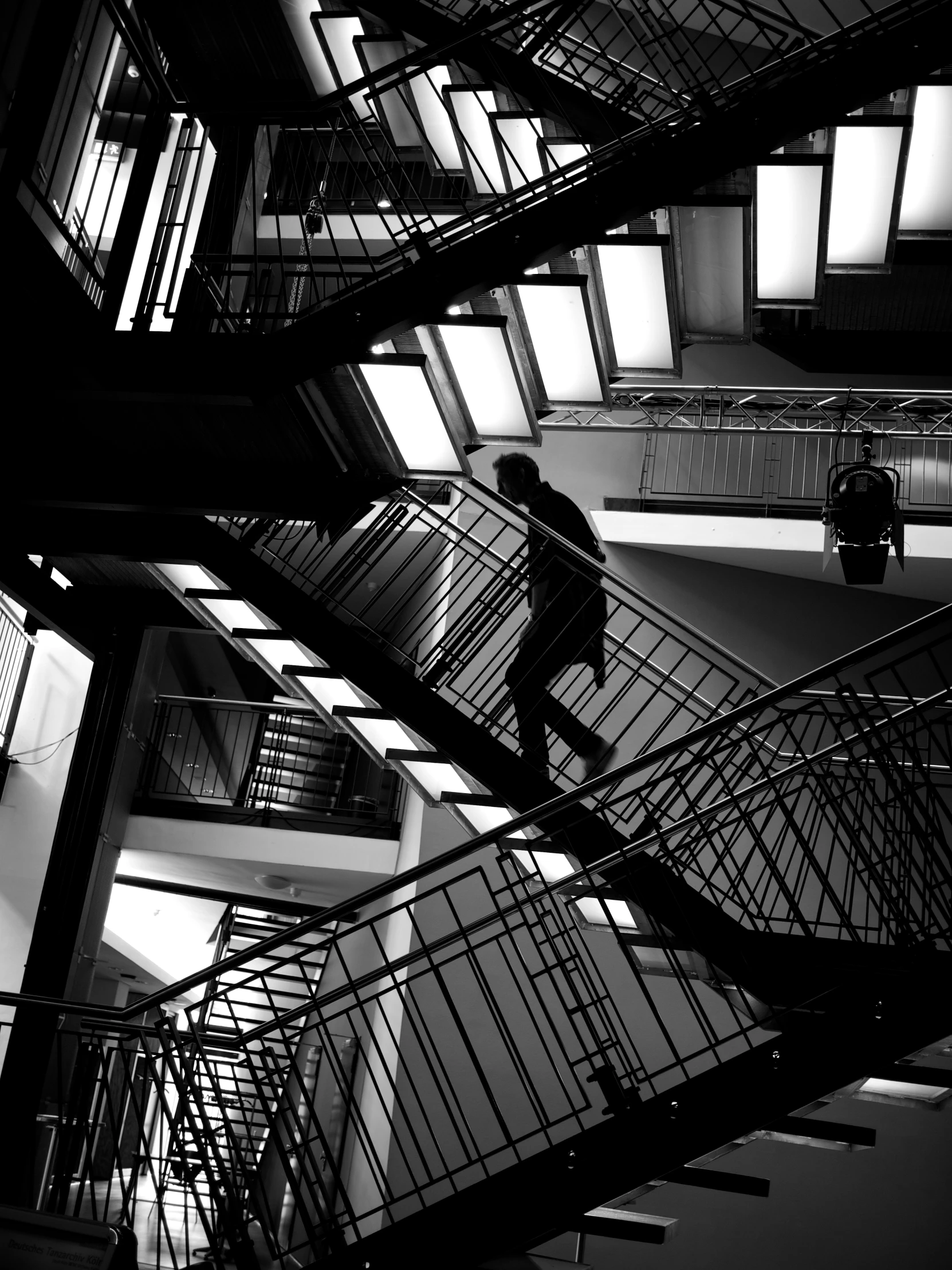 man walking up a set of stairs in a building