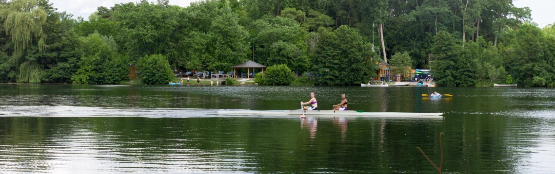 two people are riding on a paddle boat in the water