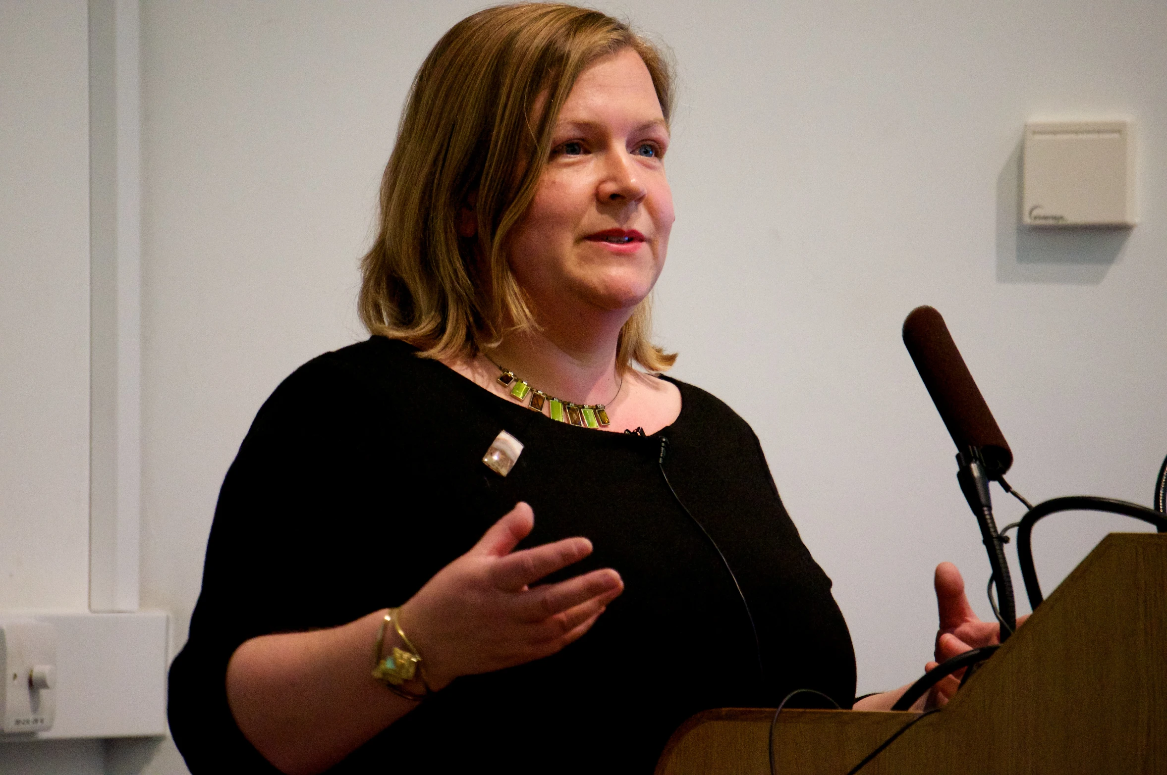 woman giving a speech at the podium