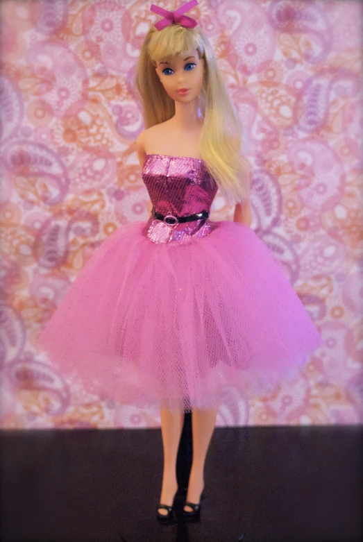 doll wearing a pink dress and shoes