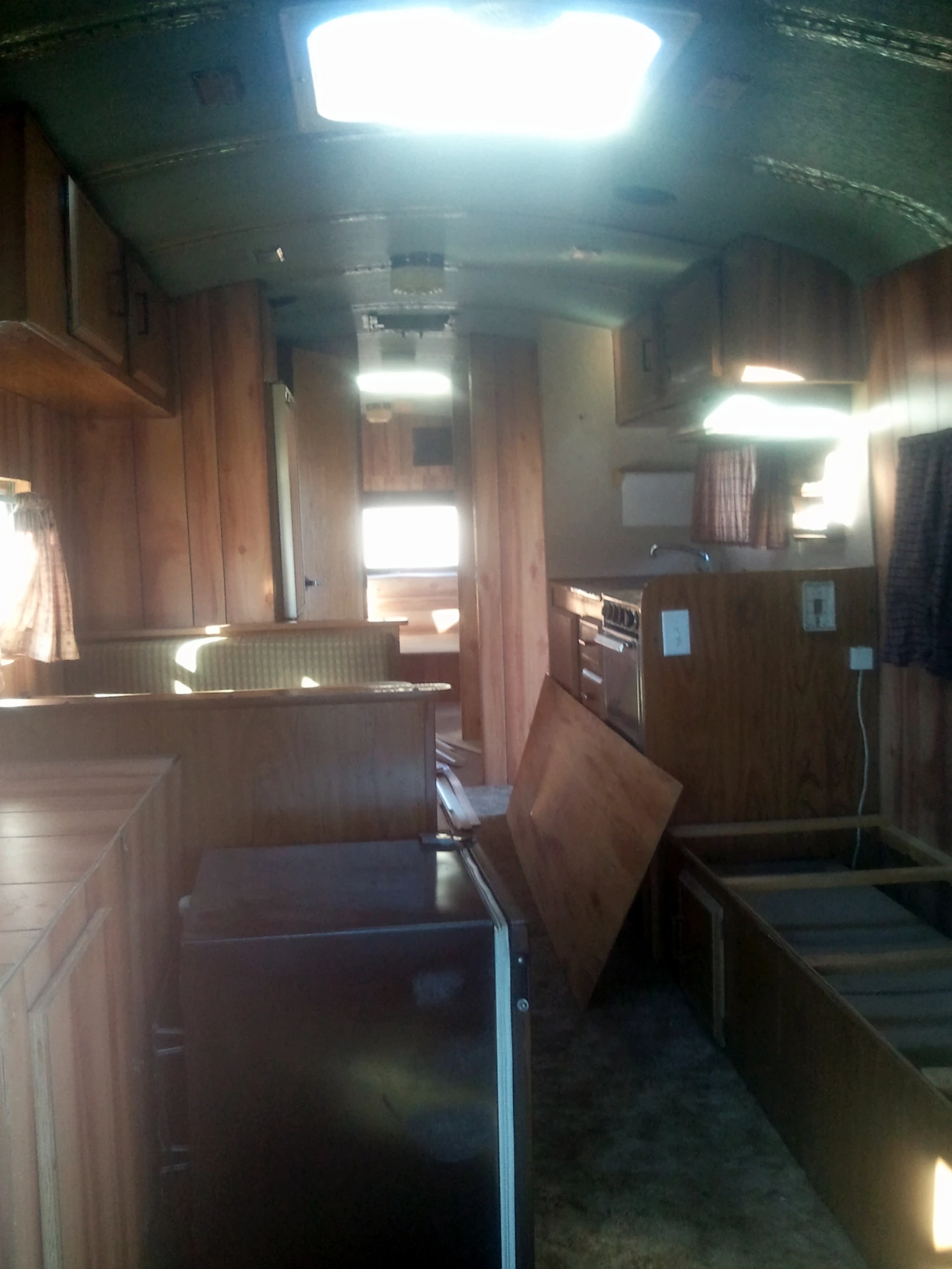 the inside of a trailer with wooden paneling