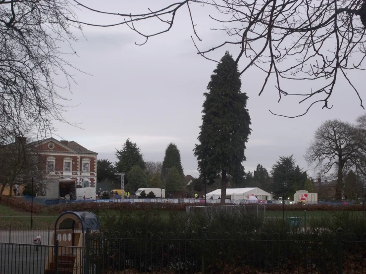 the house sits in the distance, and the building is across the street from it