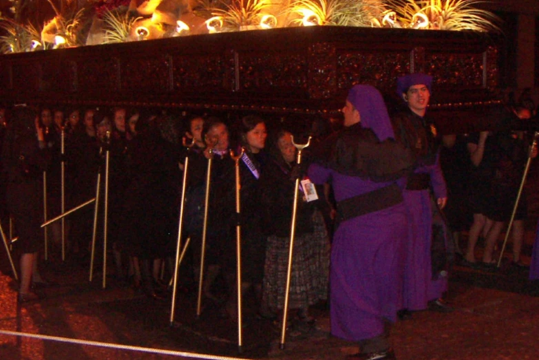 women dressed in purple clothes standing next to each other