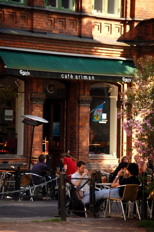 a restaurant sitting outside with people eating at tables