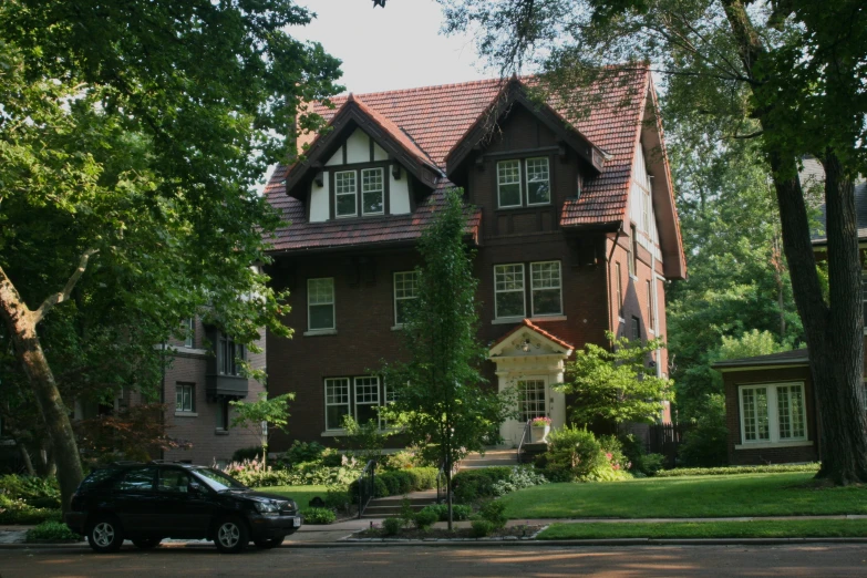 a car parked in front of a house that's surrounded by trees