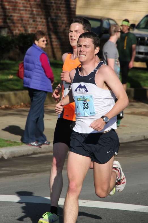 man running in a marathon with others nearby