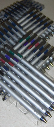 several different sized pens sitting in front of each other