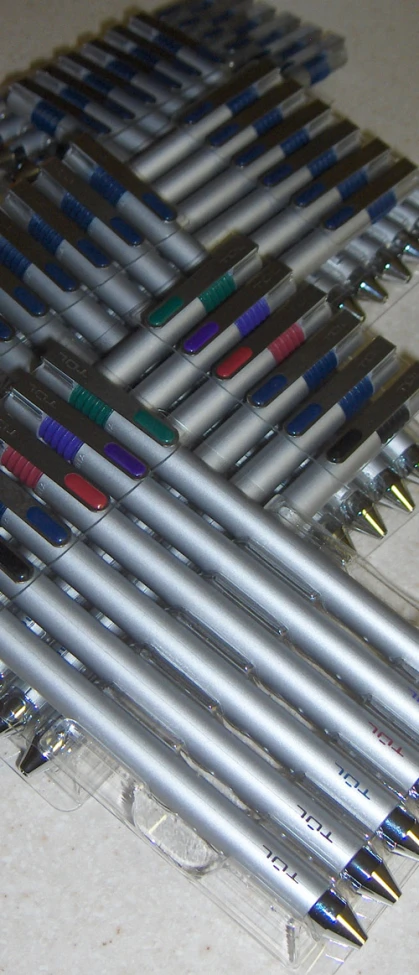 several different sized pens sitting in front of each other