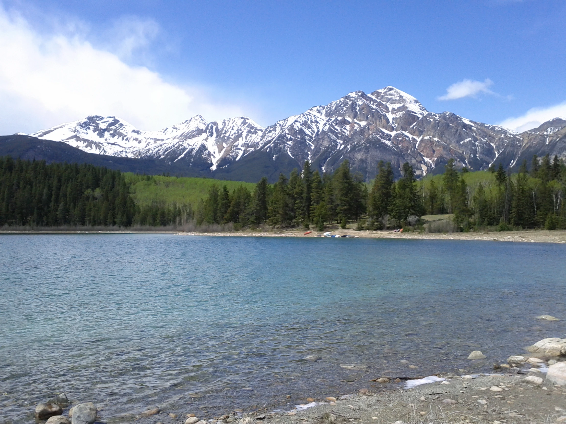 a view of a beautiful mountain lake in the middle of a forest