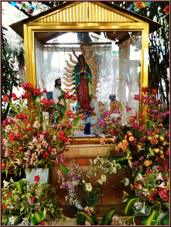 a shrine surrounded by various colorful flowers and plants