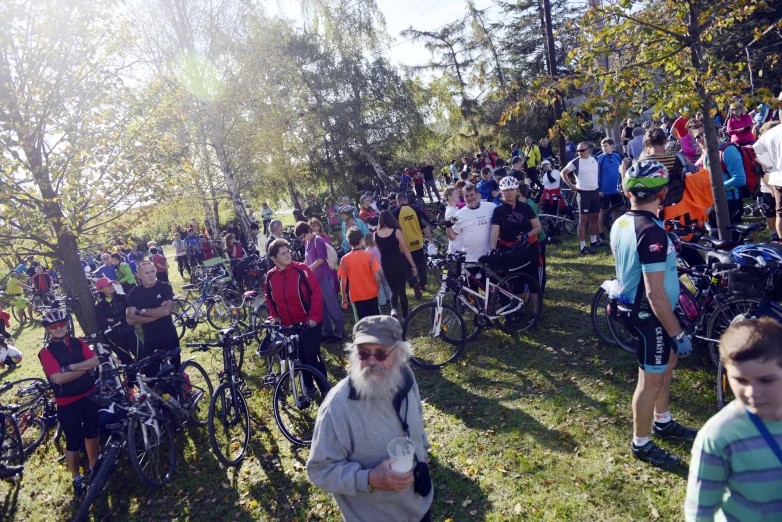 many bikers are lined up near their bikes