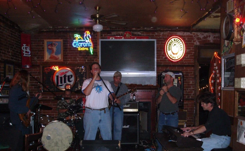 a man playing a musical instrument in a bar