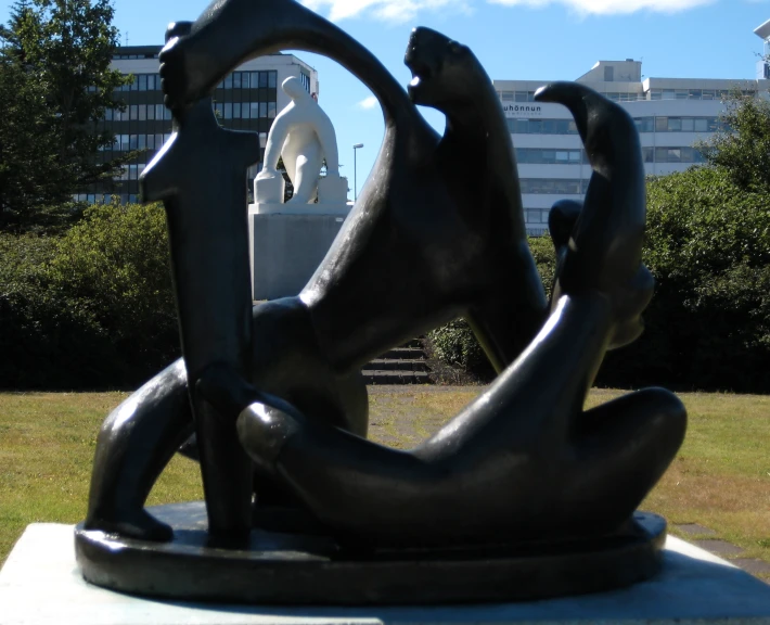 sculpture of two people sitting on the grass