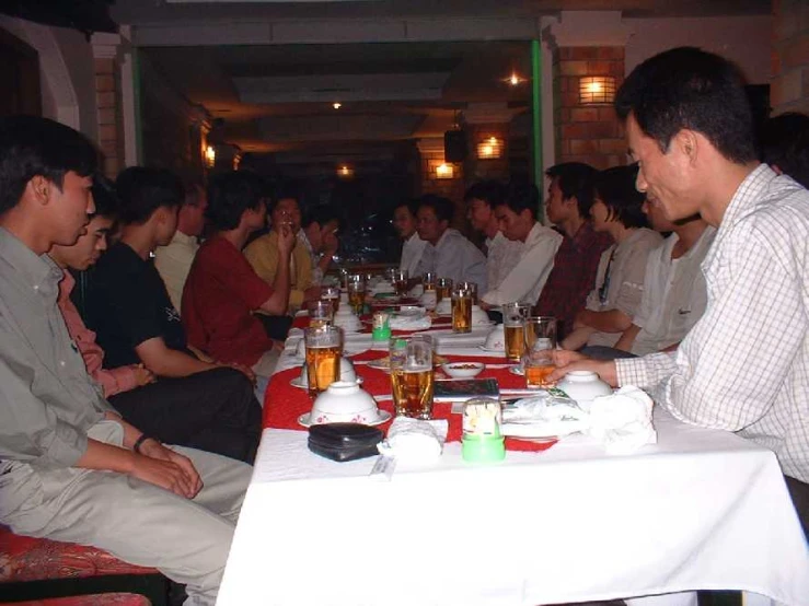 people sitting around tables with drinks in front of them