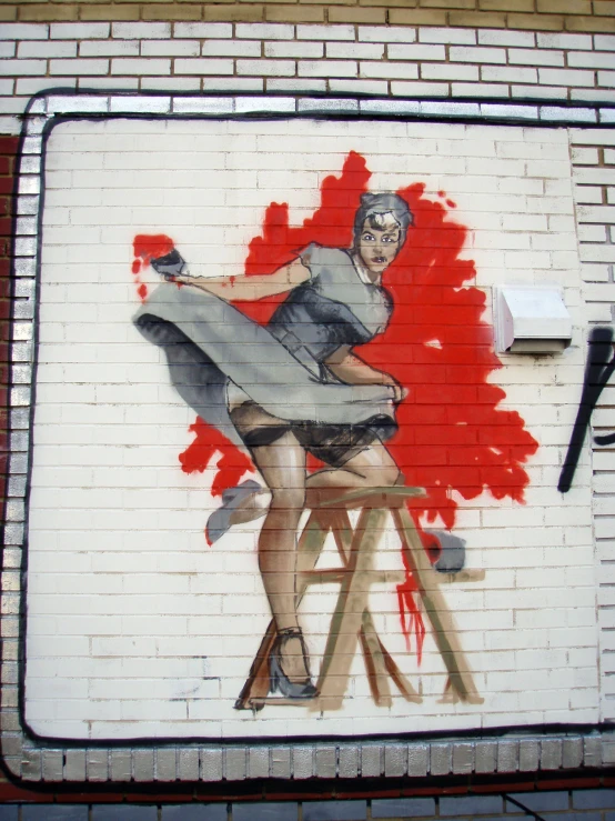 a mural of a woman on a chair