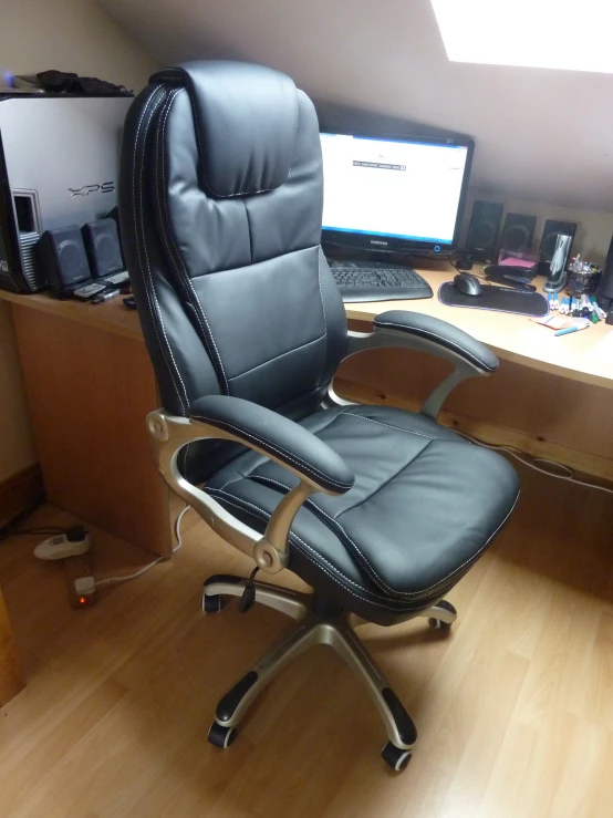 this is a black office chair sitting in front of a computer