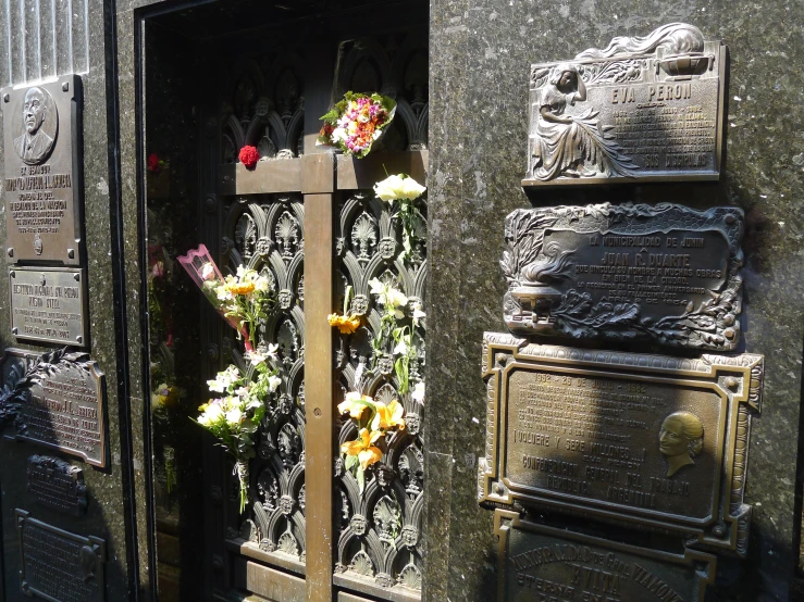 flowers decorate the names and graves on the sidewalk