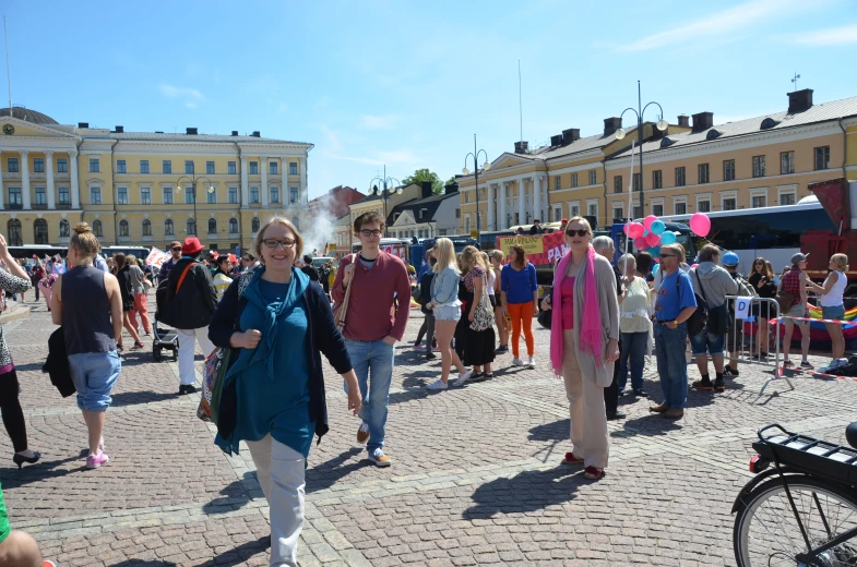 people in a town square, looking at a man walking down the street