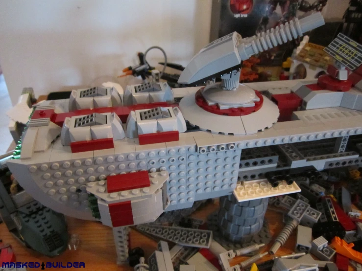 a huge lego battleship with red accents on a table