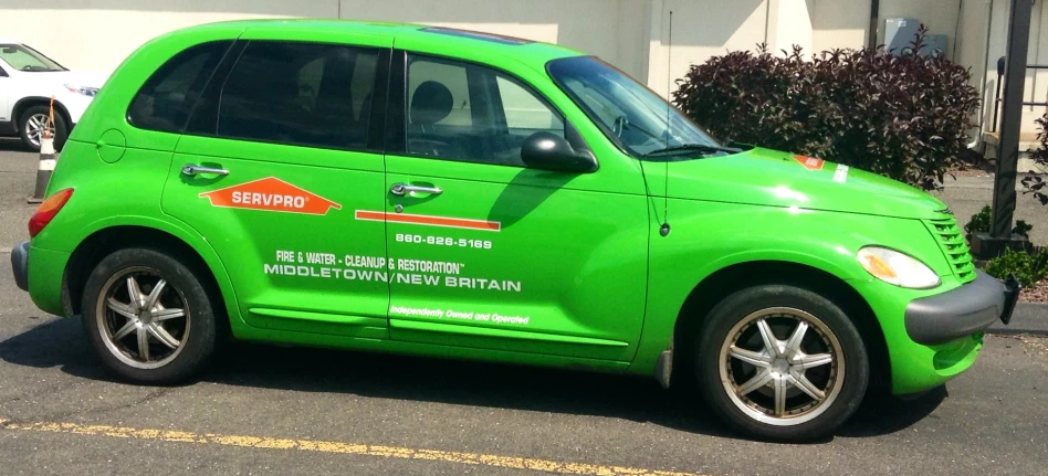 a green car with a foreign language on it