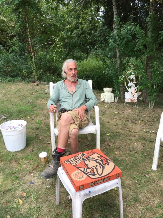 man sitting on a chair with artwork drawn on the back