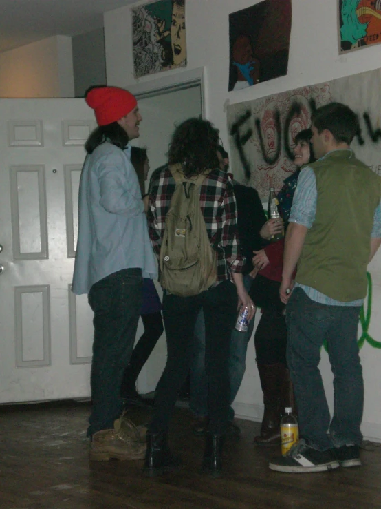 a group of young people standing together in a living room