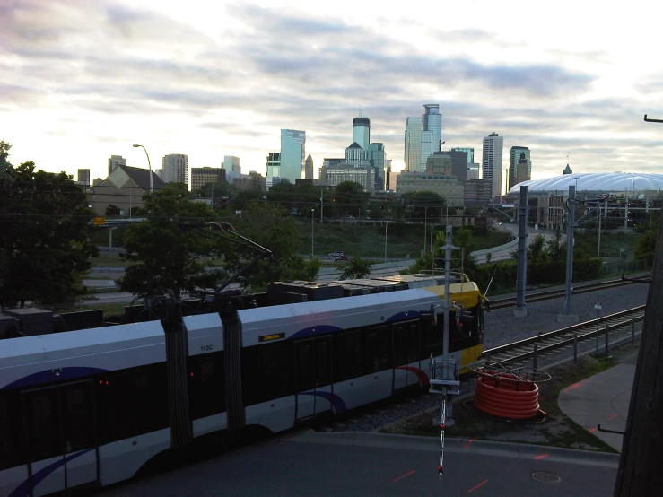 a train traveling along tracks next to a city