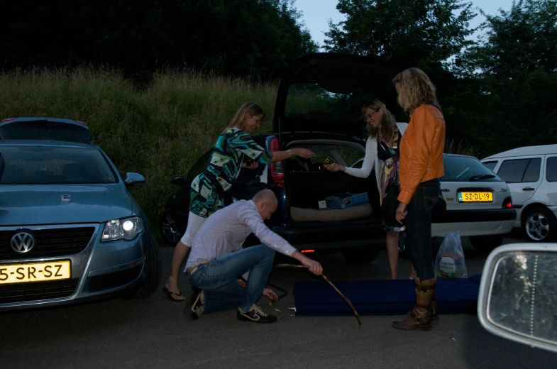 three women are loading up their car together