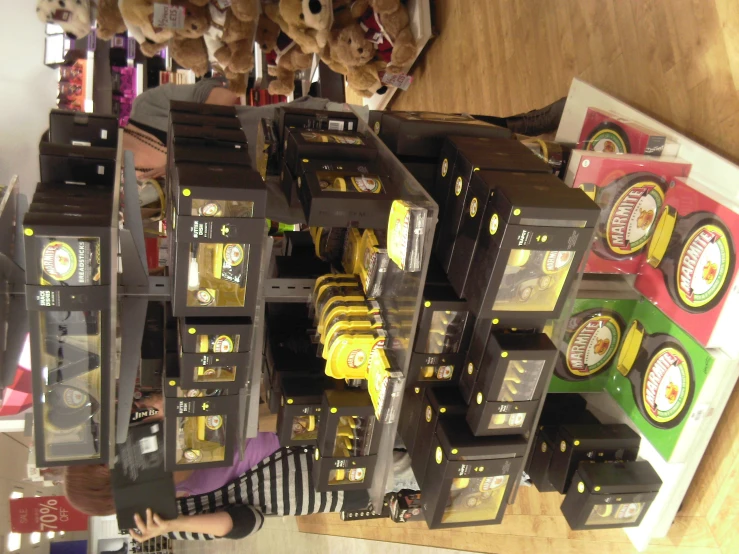 a woman looking at several different clocks on shelves