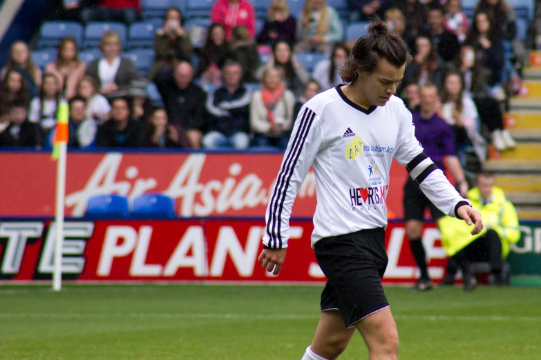 man in white uniform preparing to kick a soccer ball