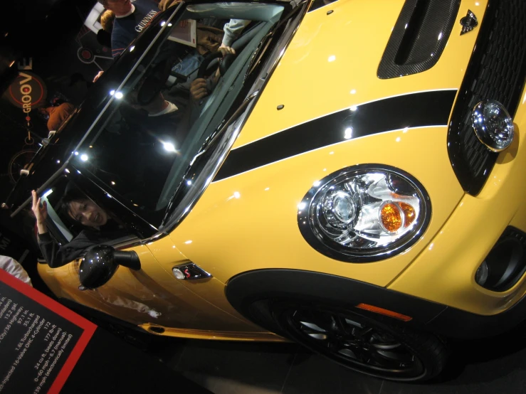 the front end of a yellow sports car