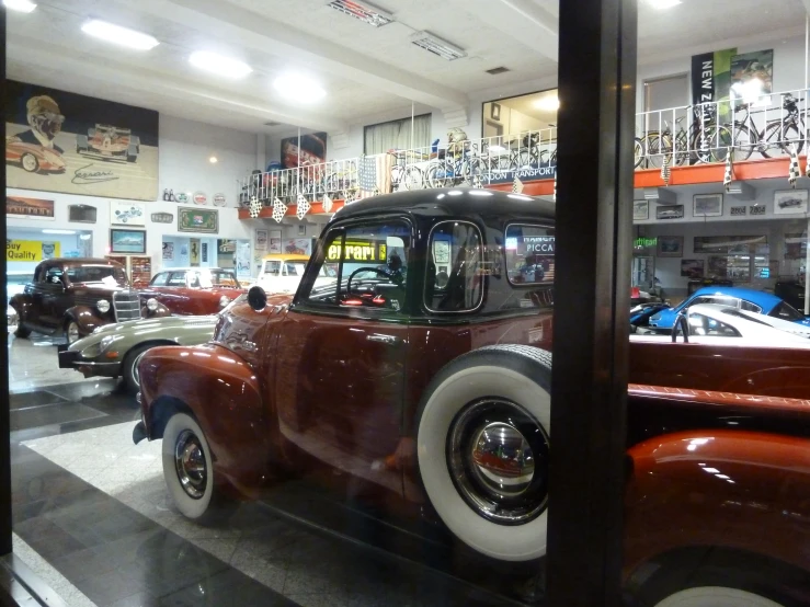 vintage trucks are on display in an auto museum