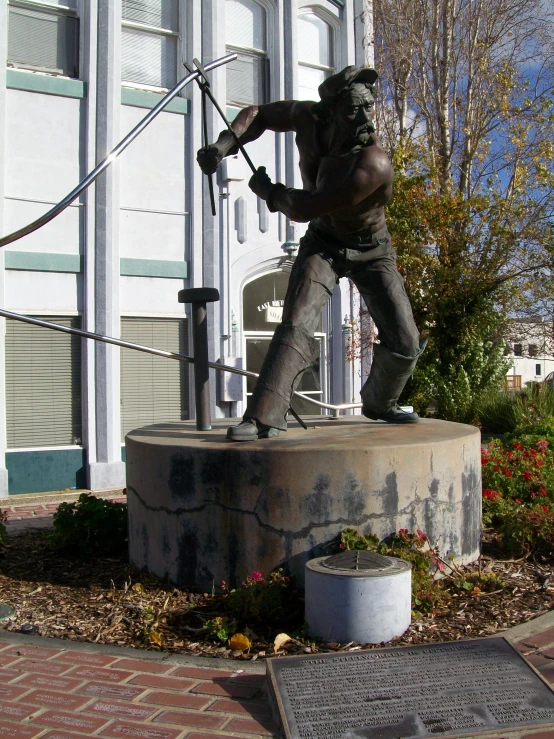 a statue of a man holding soing in his right hand