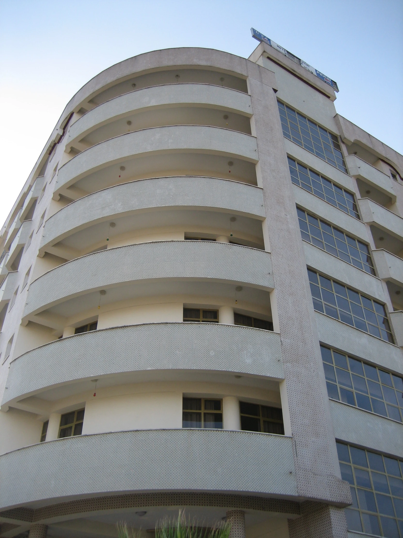 a grey building with many windows and no balconies