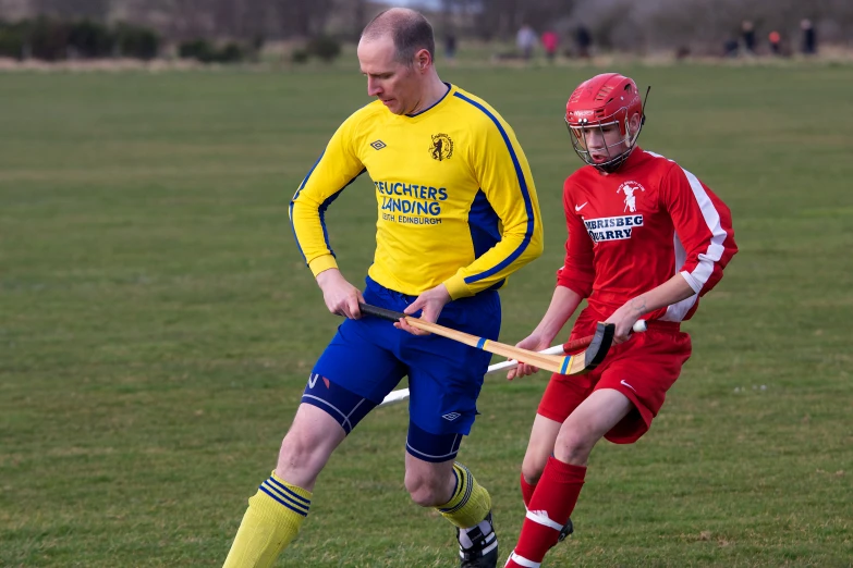 a man standing next to another man on a field