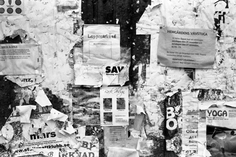 a building with torn posters hanging from it